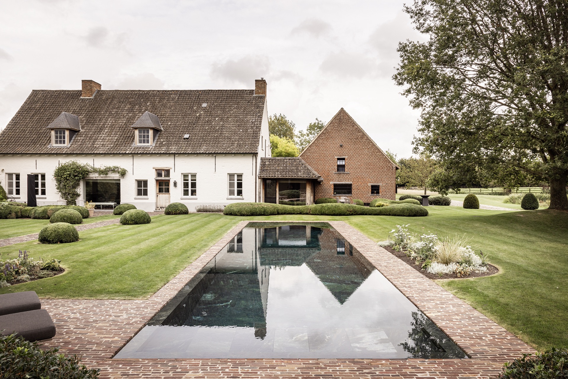 landscape garden sightline: nature-stone pool with a long sightline toward the house and trimmed garden, Luxury, Design, Exclusive, Modern, Custom Made, Special, Beautiful