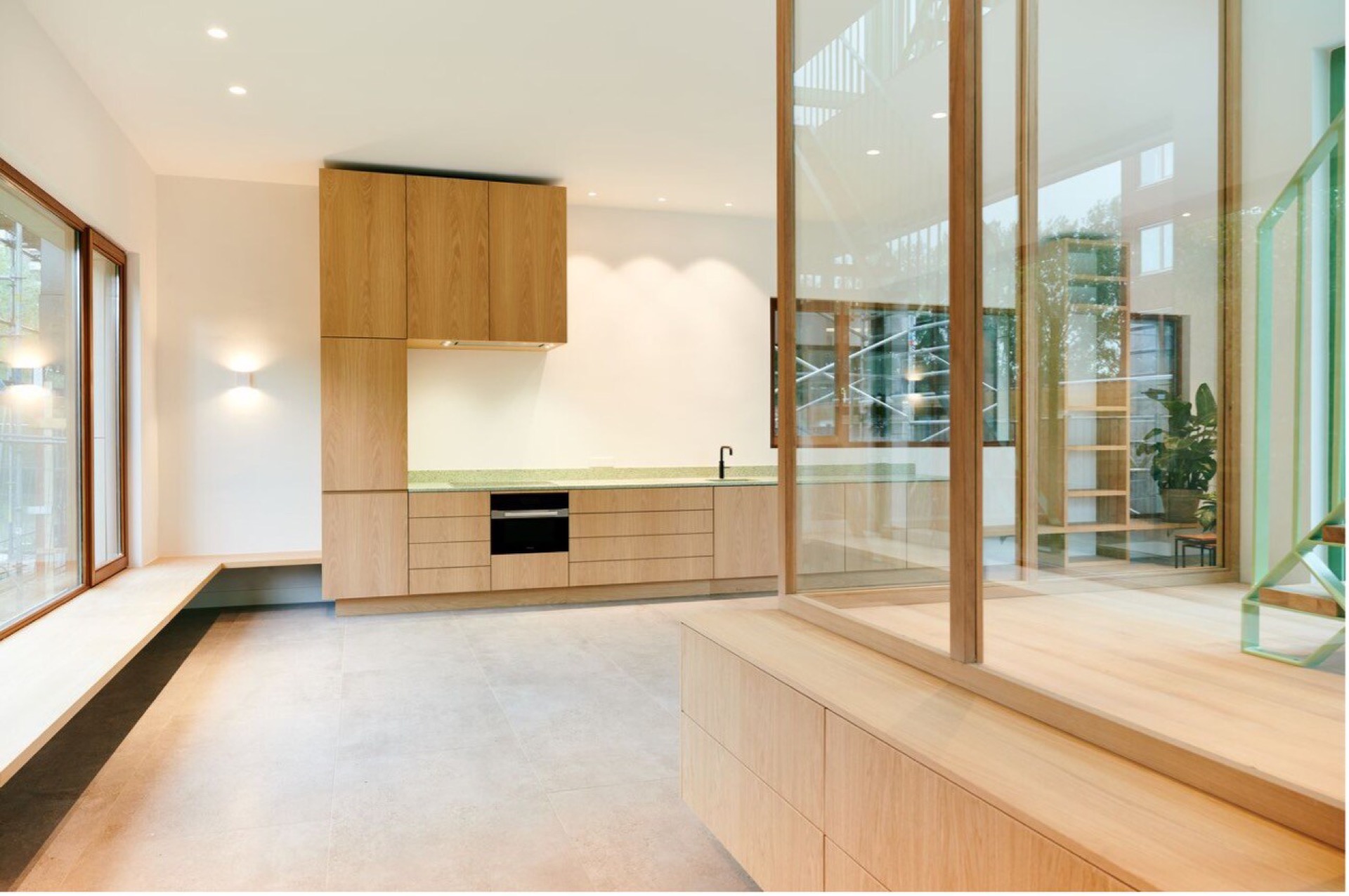 modern detached villa with glass stairwell: modern kitchen with wood fronts, natural stone countertop and large glass wall, Luxury, Design, Exclusive, Modern, Custom Made, Special, Beautiful