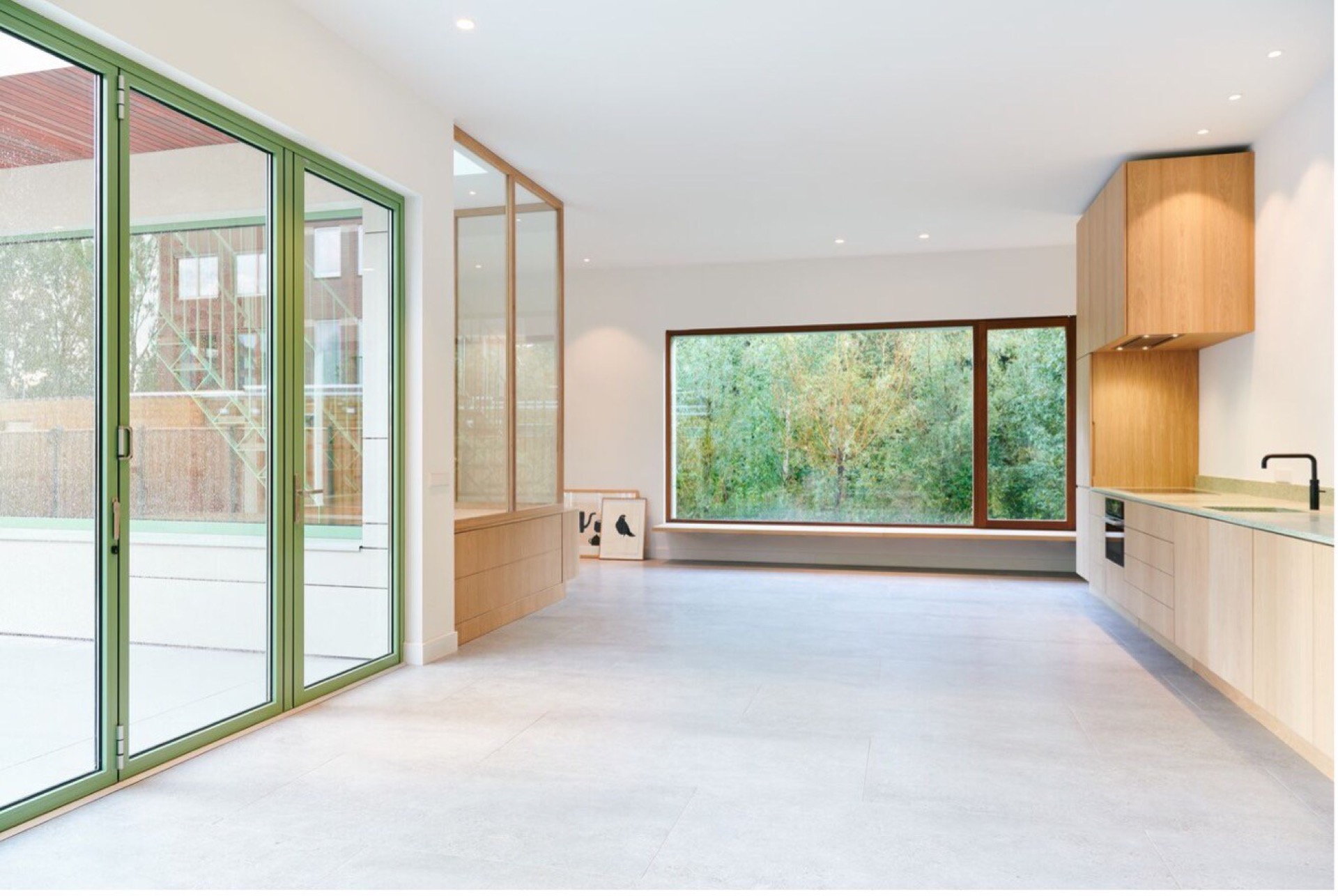 modern detached villa with glass stairwell: kitchen area with green window frames, wood cabinets and a large window, Luxury, Design, Exclusive, Modern, Custom Made, Special, Beautiful