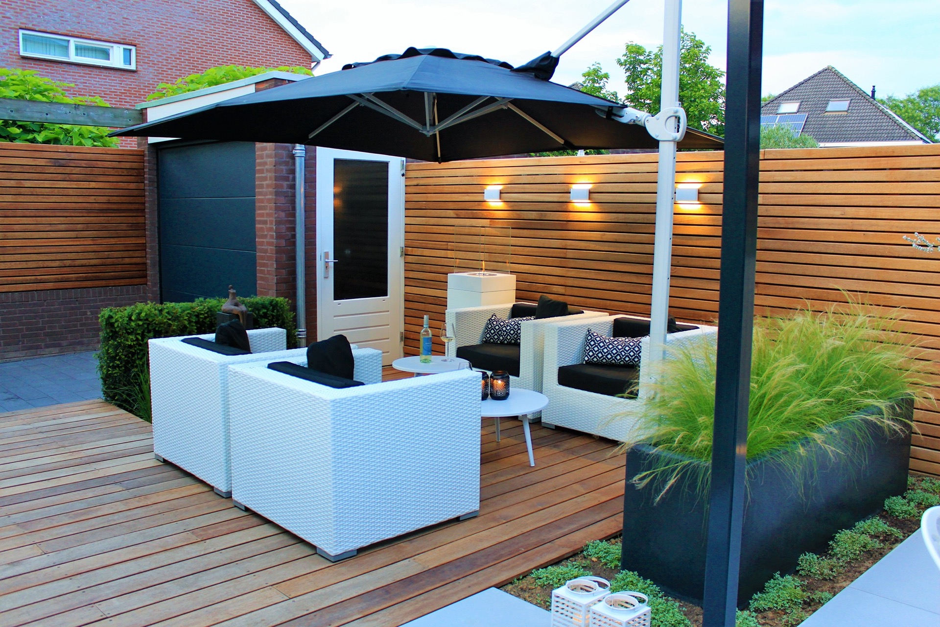 Giardino moderno con area relax su decking in legno, ombrellone, parete a listelli e graminacee ornamentali, Luxury, Design, Exclusive, Modern, Custom Made, Special, Beautiful
