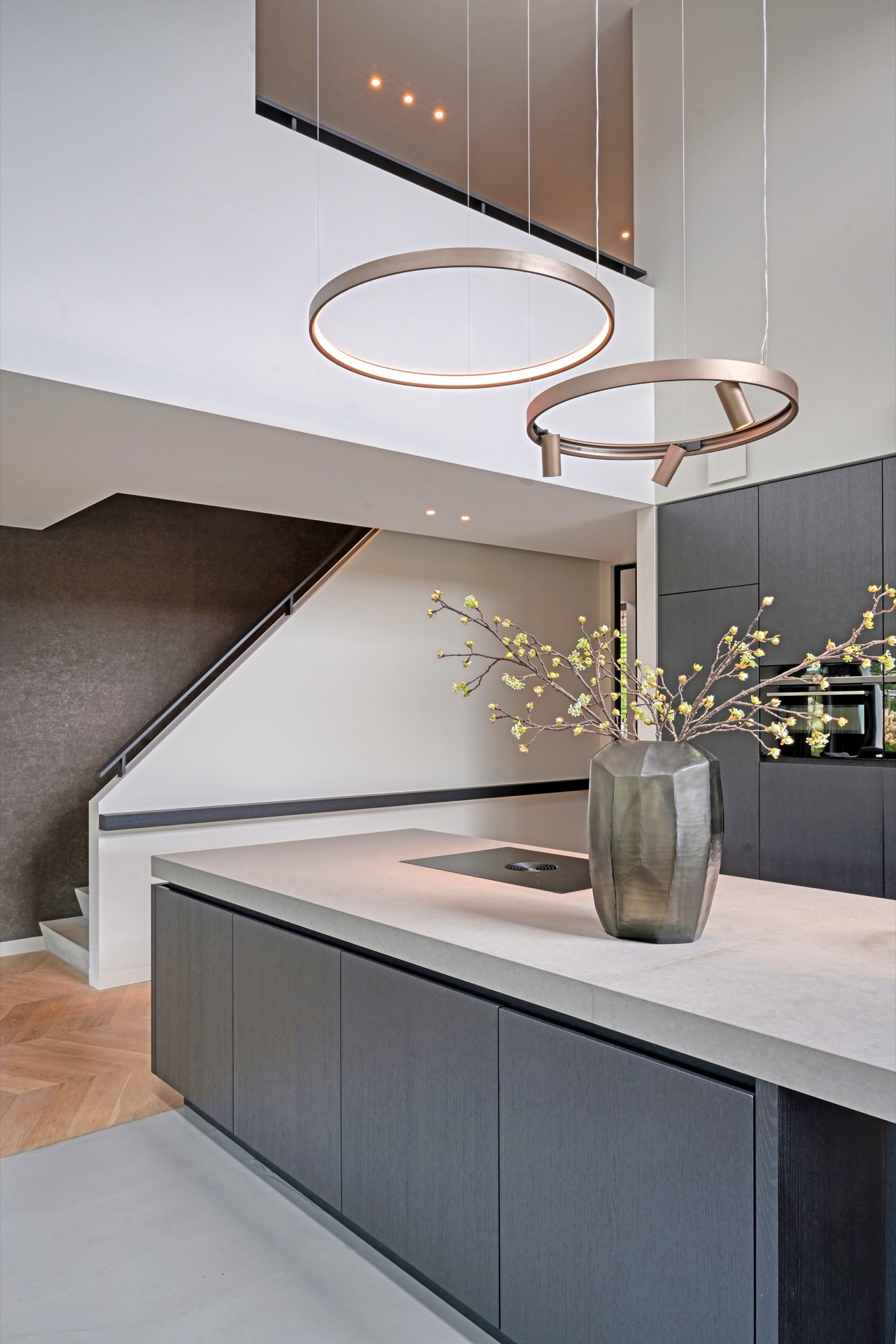 full home interior: detail of sleek kitchen fronts with round ceiling lights and warm-lit cooktop area, Luxe, Design, Exclusief, Modern, Maatwerk, Bijzondere, Mooie