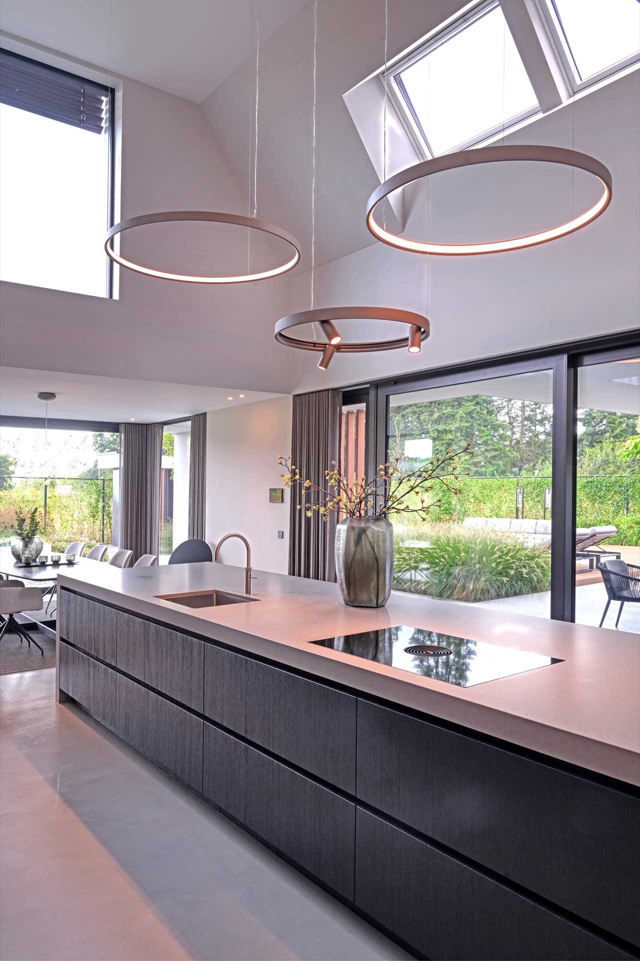 full home interior: kitchen island with round pendant lights and view through large glass facade toward the garden, Luxe, Design, Exclusief, Modern, Maatwerk, Bijzondere, Mooie