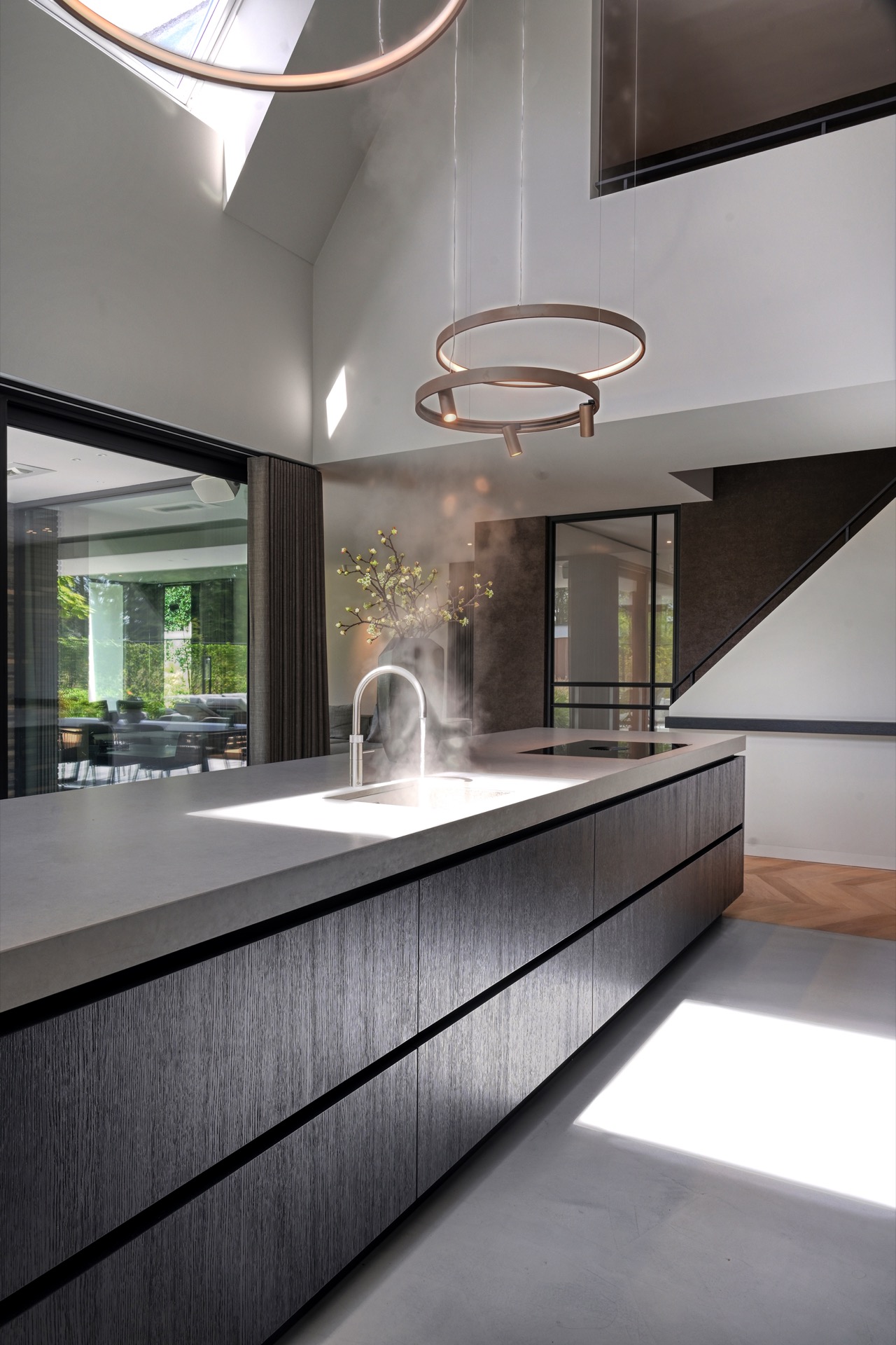 full home interior: kitchen island with warm round pendant lights and tap above the countertop, Luxe, Design, Exclusief, Modern, Maatwerk, Bijzondere, Mooie