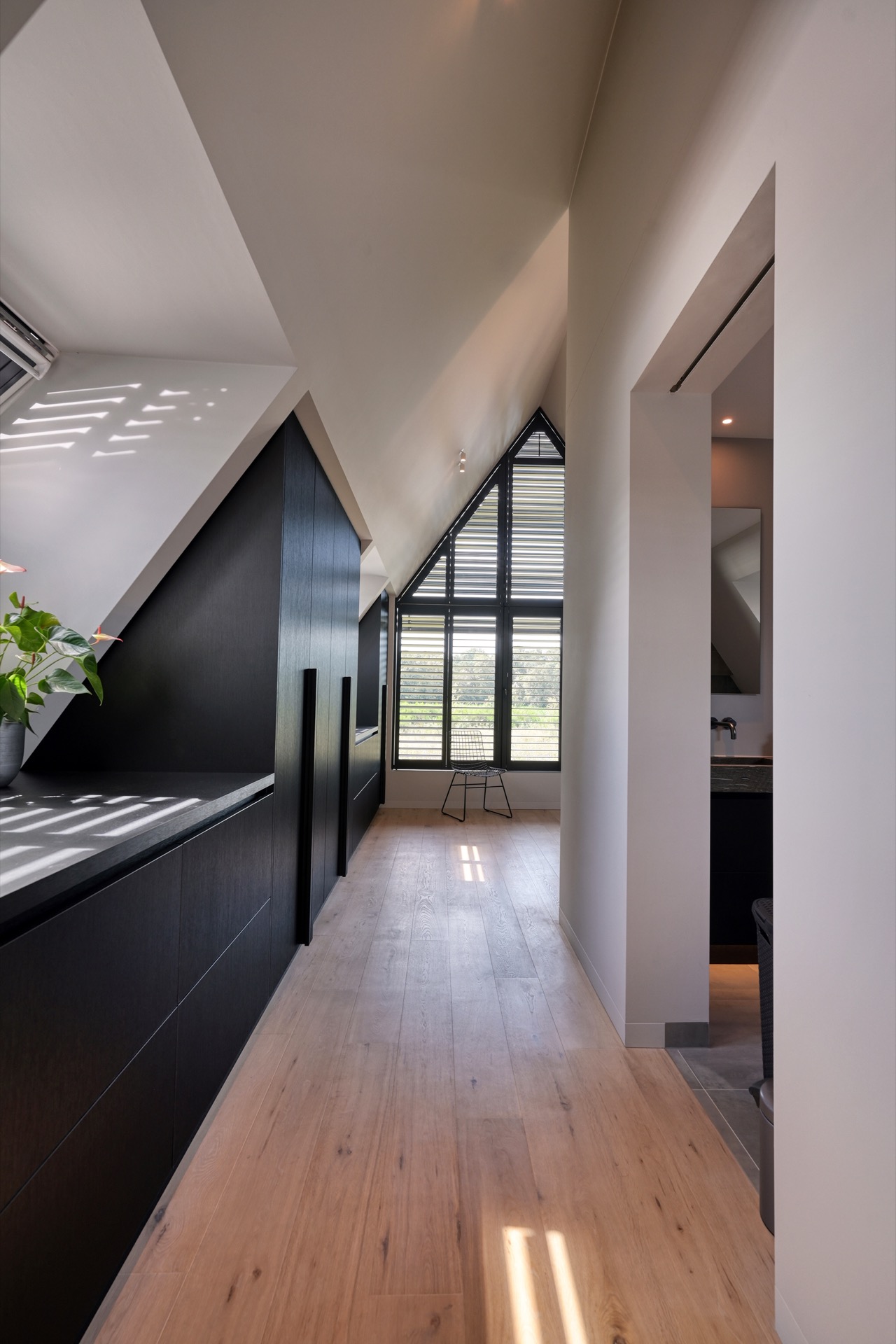 full home interior: hallway with dark built-in cabinets along sloped walls and a skylight with sunlight, Luxe, Design, Exclusief, Modern, Maatwerk, Bijzondere, Mooie