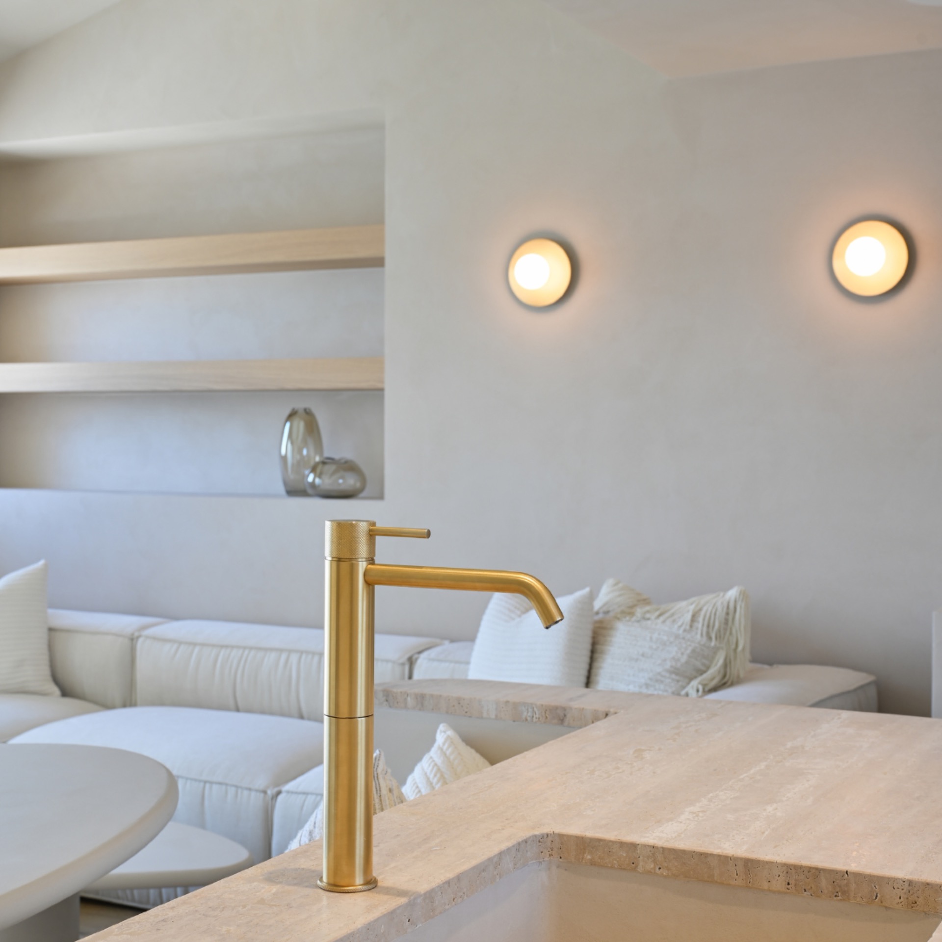 renovated luxury apartment with minimalist interior: gold faucet on a natural-stone vanity with warm round wall lights, Luxe, Design, Exclusief, Modern, Maatwerk, Bijzondere, Mooie