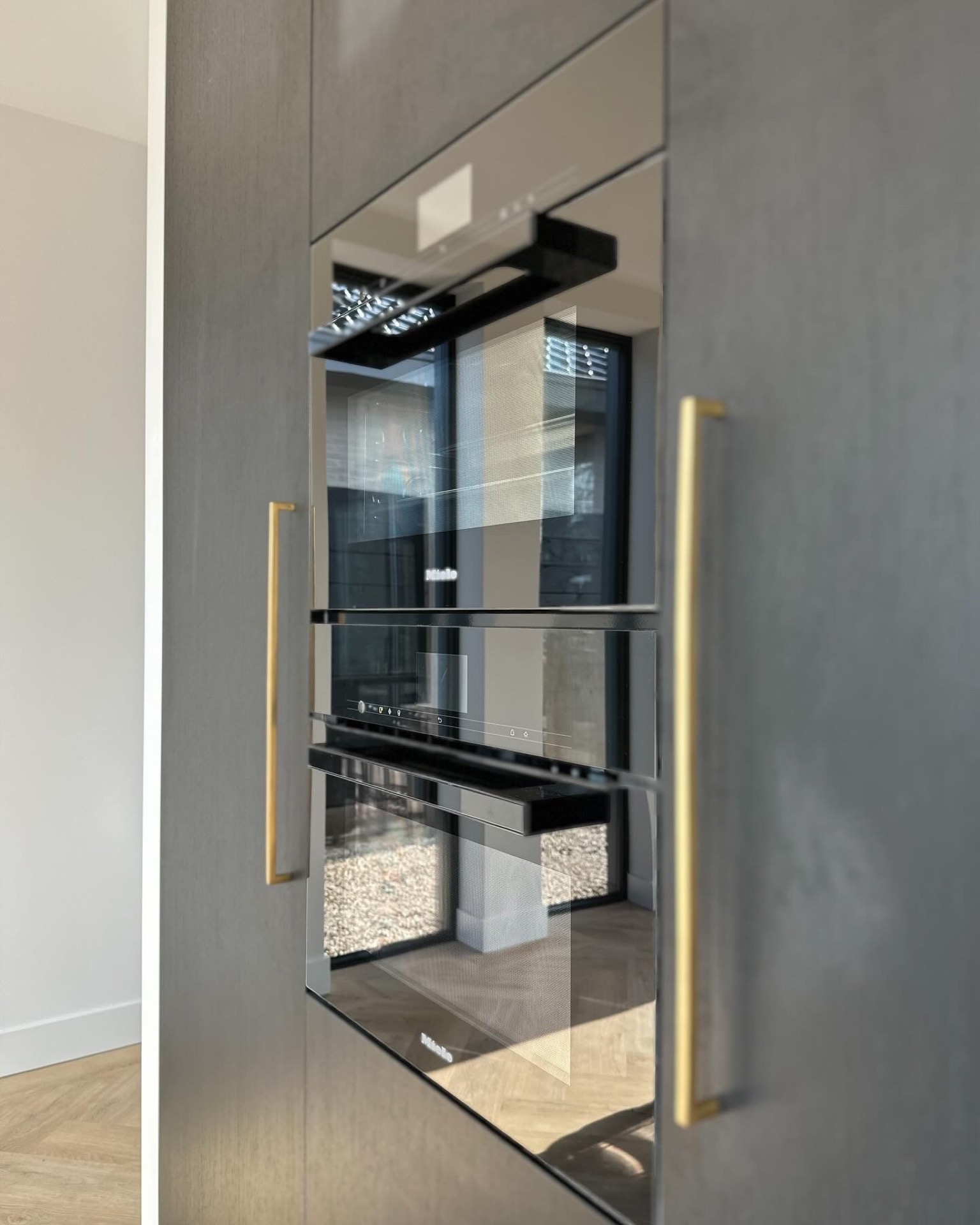 pavimento PVC spina di pesce effetto legno: dettaglio cucina con frontale in vetro e maniglia dorata su parete essenziale, Luxury, Design, Exclusive, Modern, Custom Made, Special, Beautiful