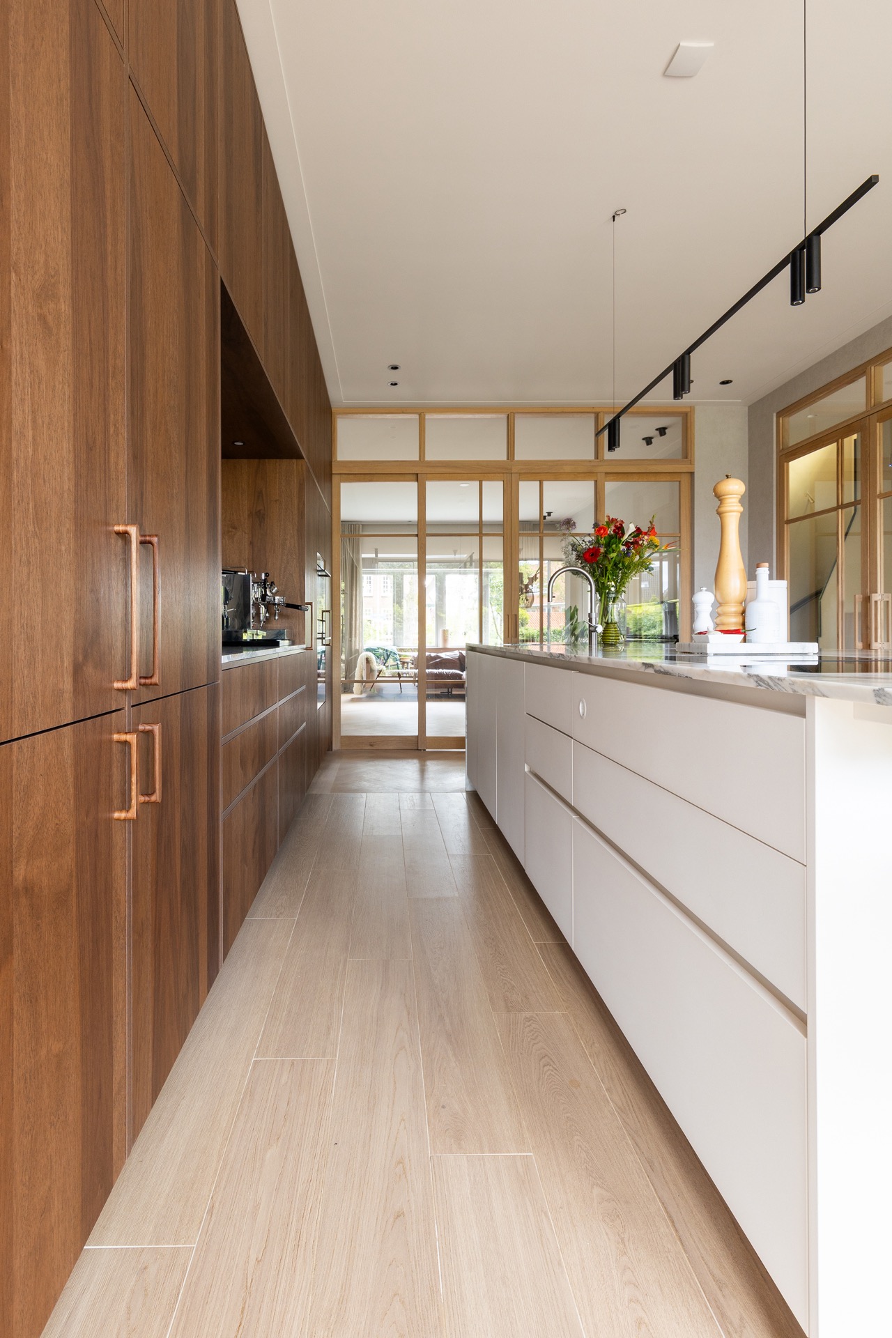modern kitchen with island and walnut veneer cabinetry: kitchen with walnut storage wall, glass partition and long counter, Luxe, Design, Exclusief, Modern, Maatwerk, Bijzondere, Mooie