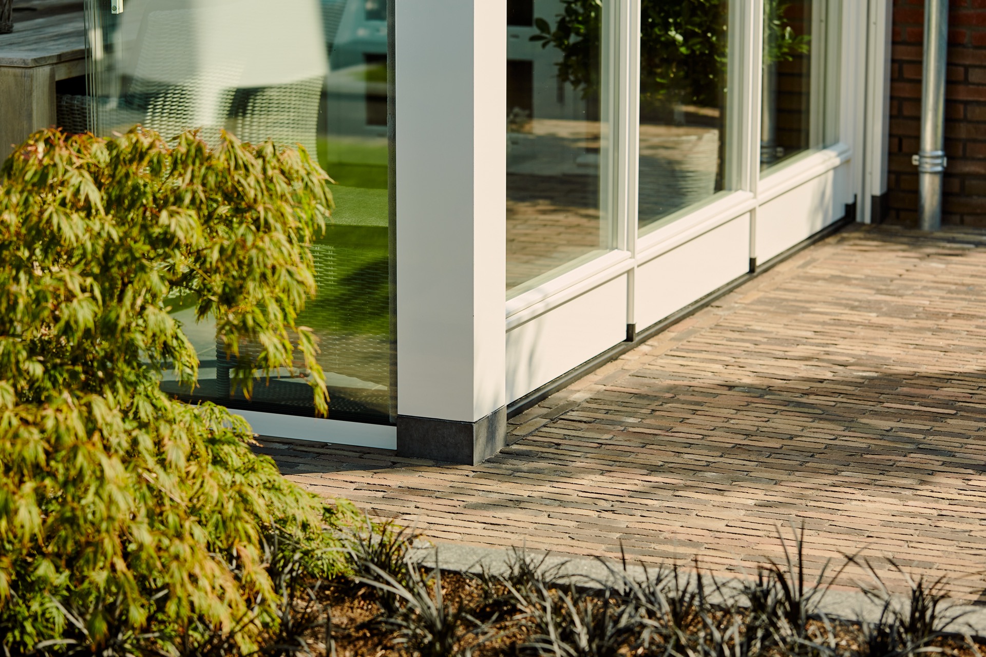 outdoor room sliding glass: detail of bottom rail and glazed wall along a paved path by the outdoor room, Luxury, Design, Exclusive, Modern, Custom Made, Special, Beautiful