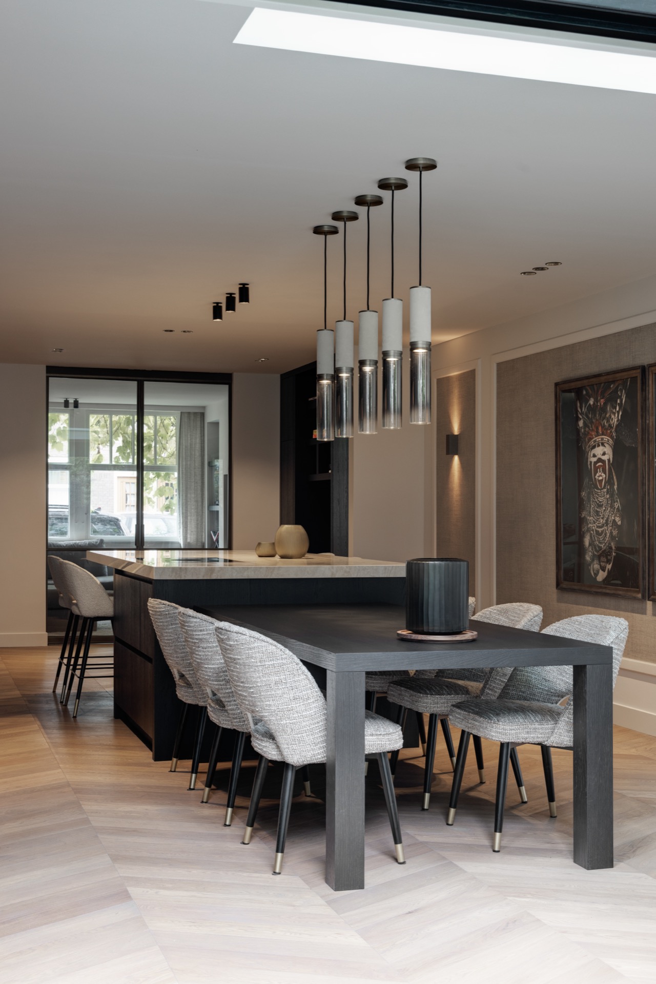 cucina in rovere con isola: fila di lampade a sospensione cilindriche sopra il tavolo da pranzo in un interno di lusso, Luxury, Design, Exclusive, Modern, Custom Made, Special, Beautiful