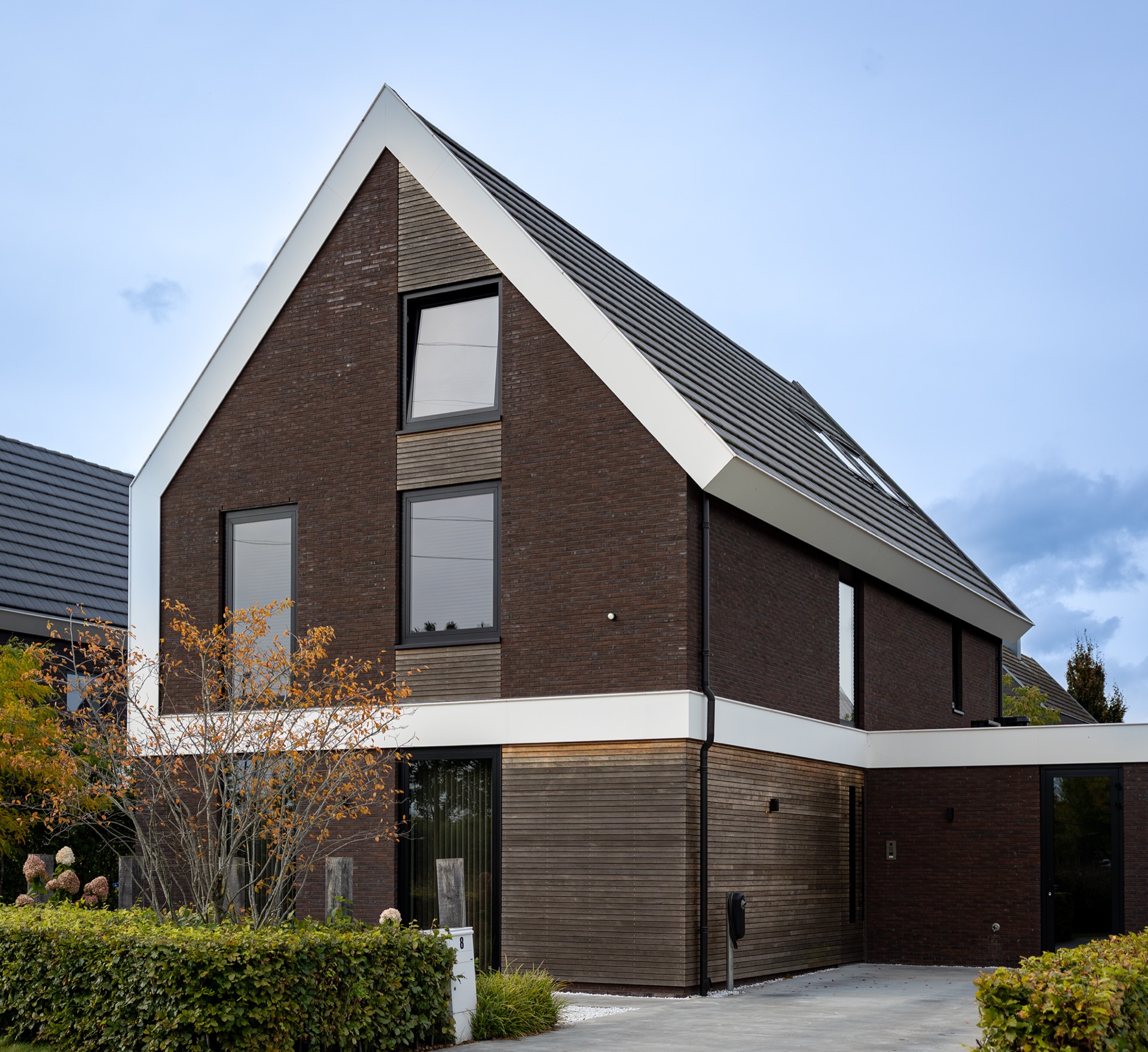 modern villa interior and finishing: modern villa facade with brick gable, dark roof tiles and windows, Luxury, Design, Exclusive, Modern, Custom Made, Special, Beautiful