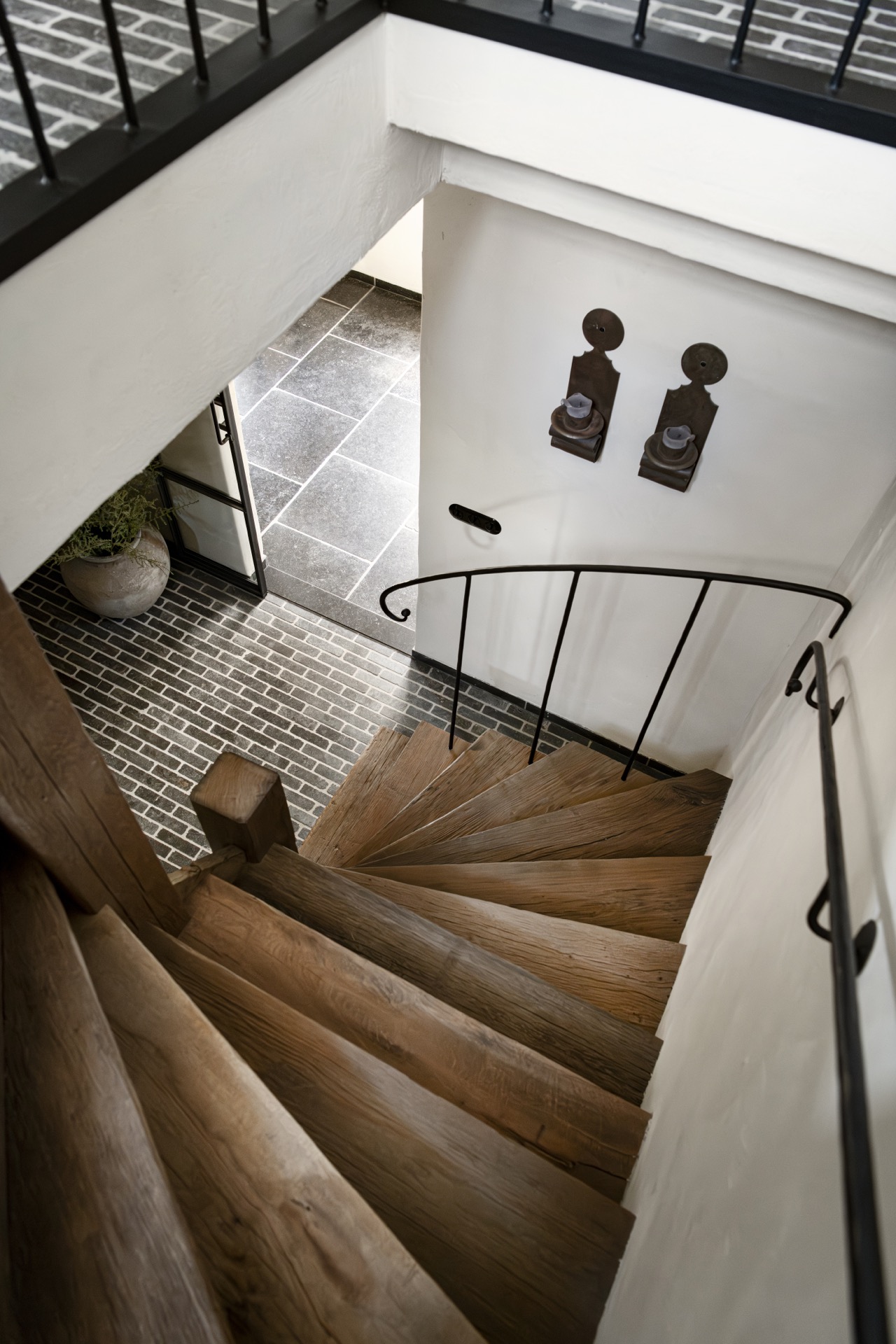 rustic country kitchen: staircase seen from above with wooden steps, black handrail and dark floor tiles, Luxury, Design, Exclusive, Modern, Custom Made, Special, Beautiful