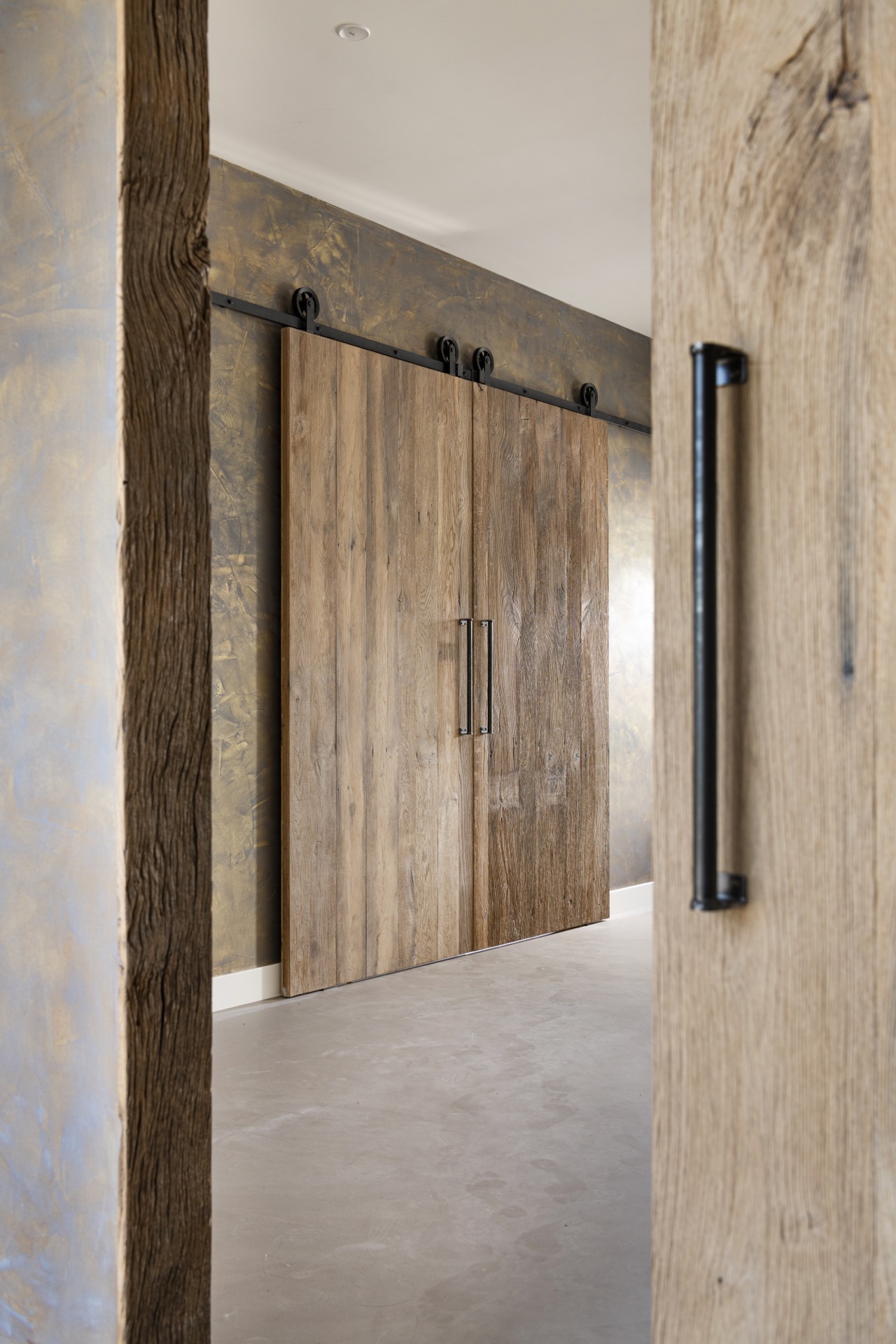 rustic industrial kitchen: bathroom detail of a wooden panel with black hardware against a stone wall, Luxury, Design, Exclusive, Modern, Custom Made, Special, Beautiful