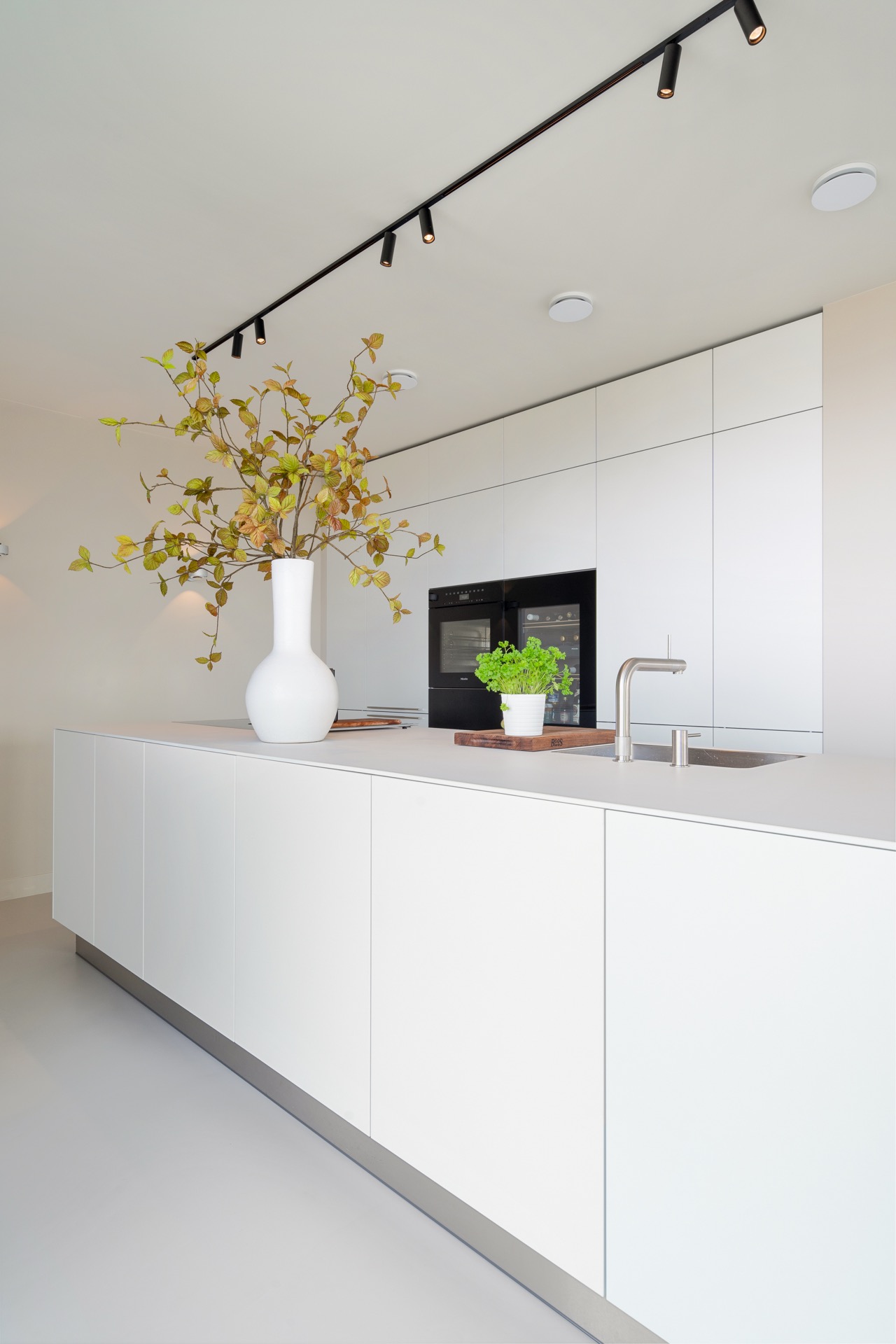 modern new-build kitchen island: modern kitchen with tall white cabinets, built-in appliances and rail lighting above the, Luxe, Design, Exclusief, Modern, Maatwerk, Bijzondere, Mooie