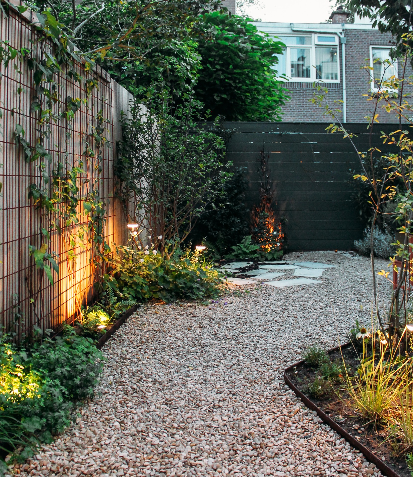 city garden lighting: city garden with ambient lighting, plants, and gravel walkway., Luxury, Design, Exclusive, Modern, Custom Made, Special, Beautiful